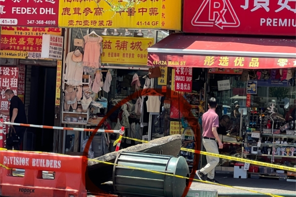 Flushing transformer explosion caused by sweltering weather overturns sidewalk concrete slab.